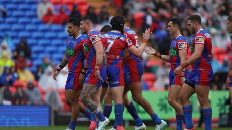 The Knights celebrate Tyson Gamble's opening try against the Warriors. Picture by Marina Neil
