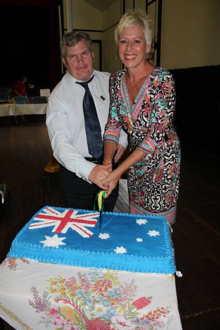 HONOURED: Dungog Shire's Citizen of the Year Jennifer Lewis cuts the Australia Day cake with Ambassador Nick Gleeson.