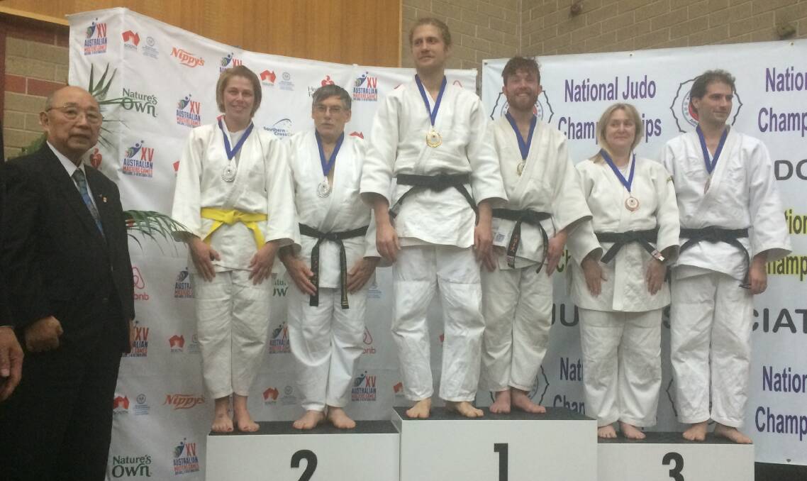 Podium finish: Lake Macquarie PCYC Judo Club's Karen Carrigan and John Locke stand in second place on the podium next to their Victorian and West Australian opponents.