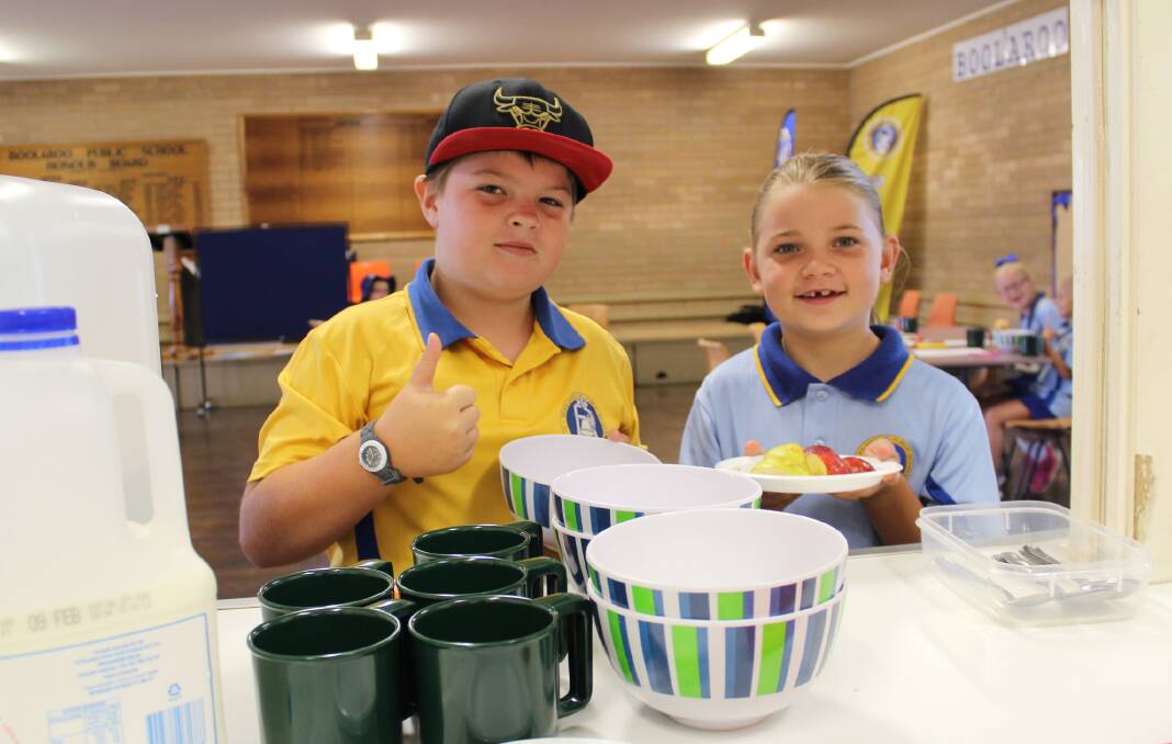 Thumbs up: Boolaroo Public School students Ayden Woellner, year 5, and Lily McCraw, year 2, help themselves to breakfast. Picture: Georgia Osland