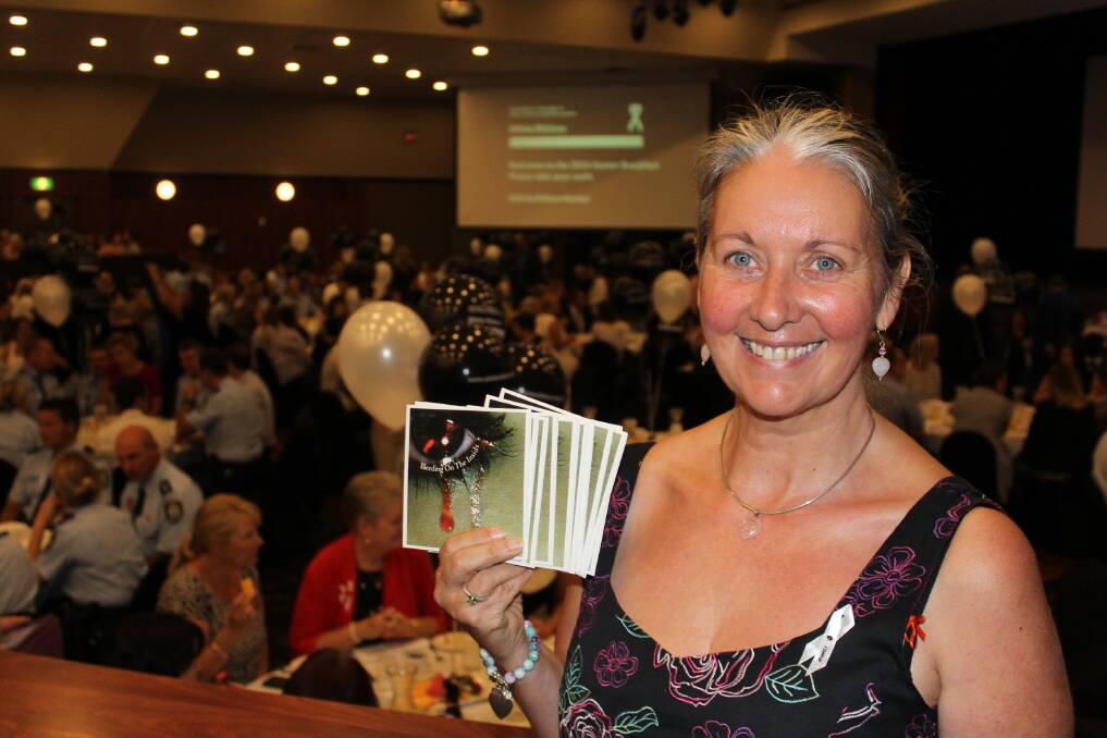 Strong: Sherynne Smith holds some copies of her CD at the White Ribbon Day breakfast at Wests New Lambton. Picture: Kim-Cherie Davidson