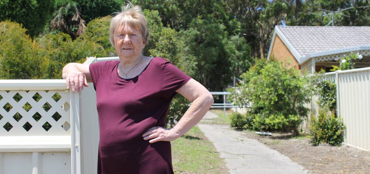 Fed up: Mount Hutton resident Kate Phillips stands next to the lane way adjacent to her home. The lane way is plagued by antisocial behaviour and graffiti.