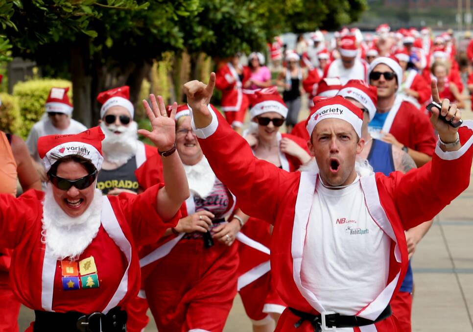 Enthusiastic: Participants in the 2013 Variety Santa Fun Run cheer as they pound the pavement in the name of charity.