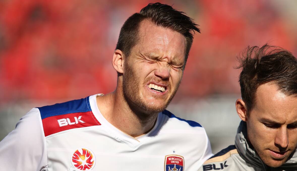 Hurt: Newcastle Jets captain Nigel Boogaard limps off the field with an ankle injury during Sunday's match against Adelaide United at Coopers Stadium. Picture: Getty Images