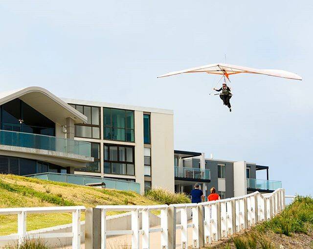 MORNING SHOT: INSTA @@tony.coady Hang glider coming in to land near bar beach #newcastlensw #hanggliding