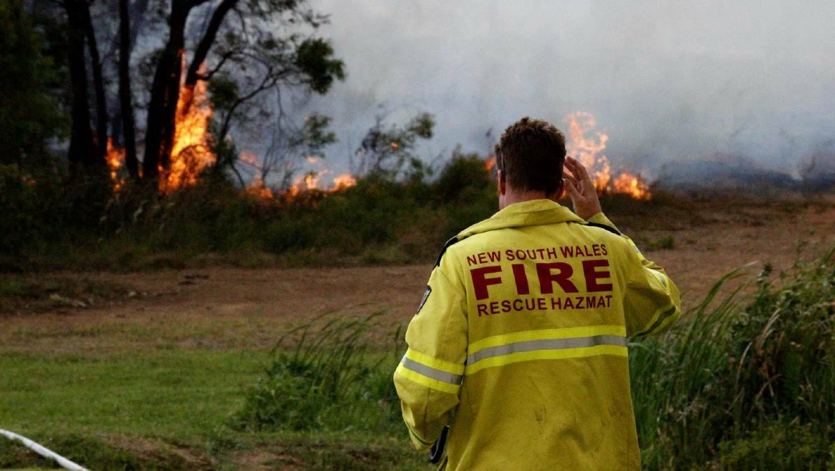 Morning shot: Firefighter battling the blazes in Kurri Kurri and Heddon Greta on Wednesday. Picture: Victoria Darcy