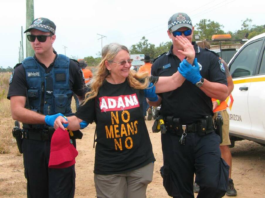 PEACEFUL PROTEST: Lynn Benn, of Mulbring, being led off by police after her arrest at Abbot Point coal 