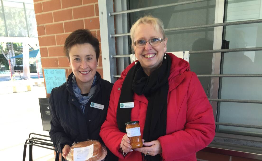 Ellice Schrader and Johanna Rosee at their cake stall at the Cessnock West Public School polling booth.
