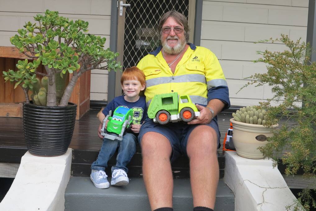 BEST OF FRIENDS: West Wallsend's Lincoln Hill with Lake Macquarie City Council truck operator David Roworth. They have formed a special bond over garbage trucks.