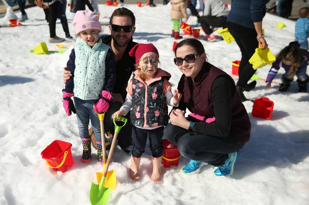 FAMILY AFFAIR: John and Kate Smith, with Ellie, 4, and Hannah, 2, of Lambton enjoy some snow time at Hunter Valley Gardens. Picture: Marina Neil
