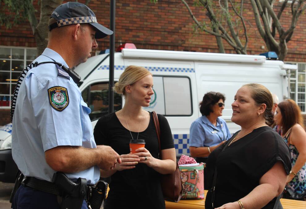 BEING HEARD: Mel Chamberlain, left and Bee Roals raise concerns about Hamilton's late-night crime and anti-social behaviour with police officer Dave Piddington at Coffee with a Cop at Hamilton on Wednesday.