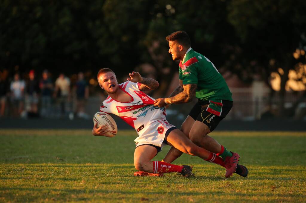 Souths' Jacob Afflick is tackled by Wests player Willis Alatini in Newcastle Rugby League.