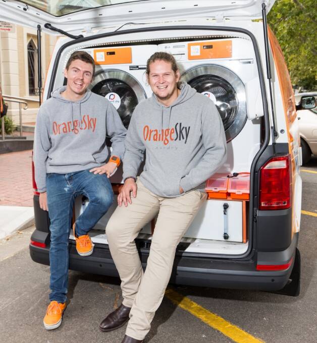 DO-GOODERS: 2016 Young Australians of the Year Nic Marchesi, left, and Lucas Patchett will bring one of their Orange Sky Laundry vans to Newcastle this week.