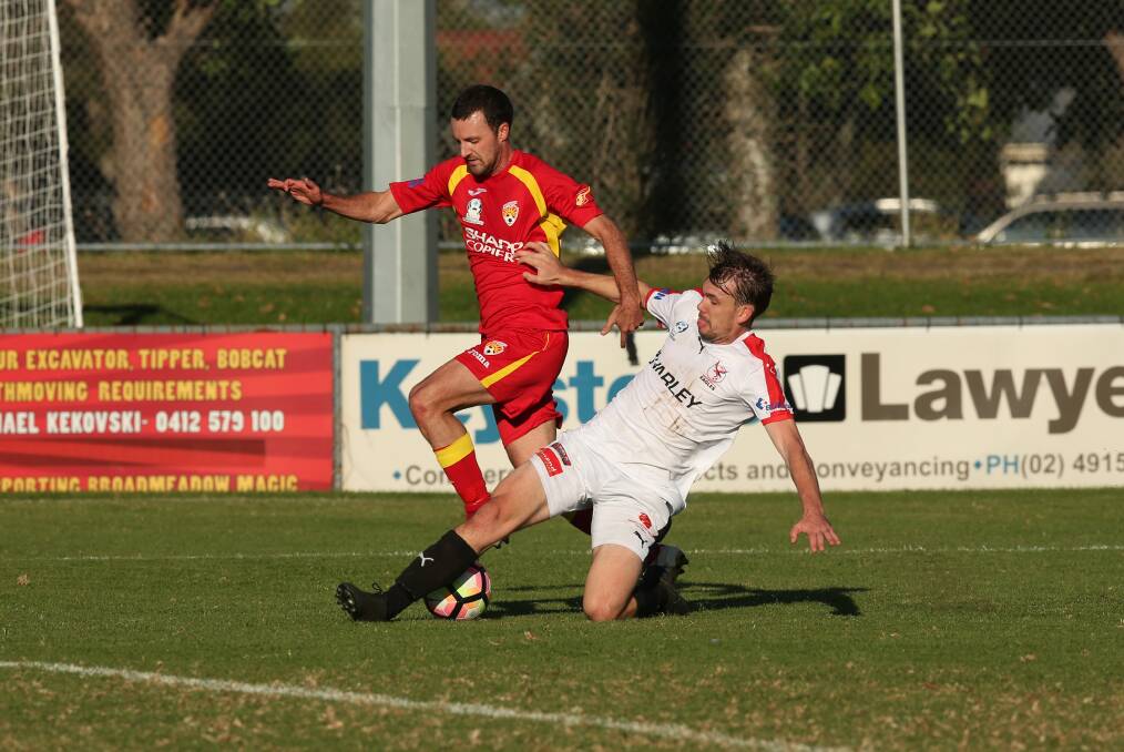Broadmeadow player James Virgili is tackled in their NPL match against Edgeworth.