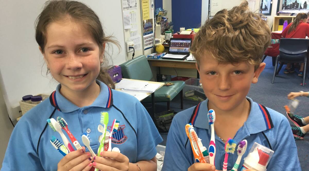 MAKING CHANGE: Jewells Primary School students Breanna Naylor and Elijah Evans were happy to help save oral products from landfill.