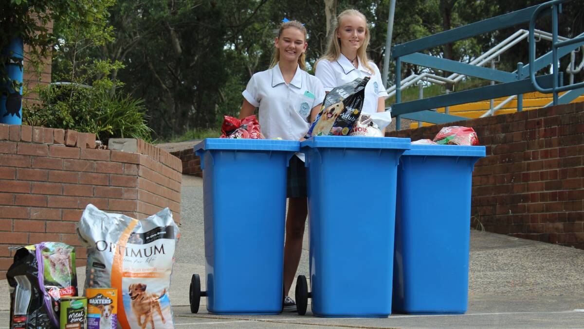 HUGE RESPONSE: Cardiff High School students Tiffany McLean, left, and Cayla Blanch have helped drive a Dog Food Run for farm dogs in Queensland.