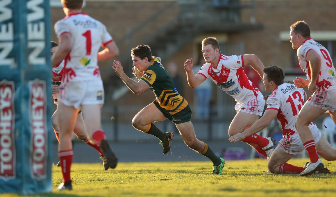  Macquarie's Mitch Manson sprints for the try line against South Newcastle at Townson Oval.