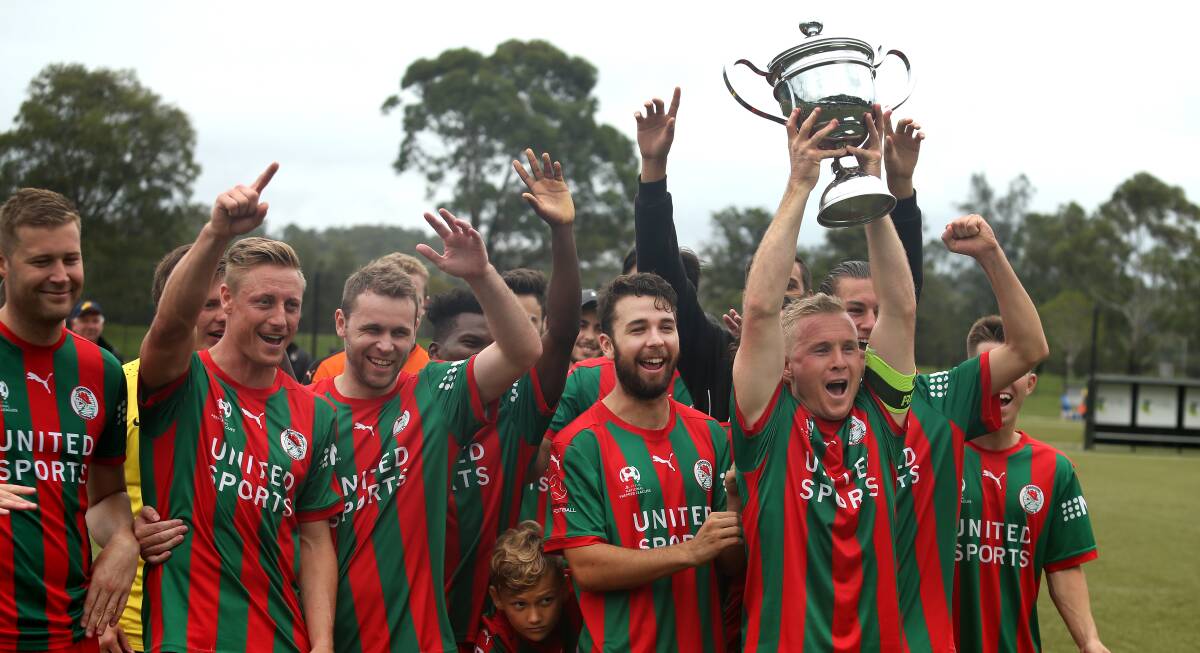 WINNERS: Adamstown captain Robbie Turnbull holds up the Heritage Cup after Rosebud defeated Edgeworth in the final at Speers Point on Sunday. Picture: Marina Neil
