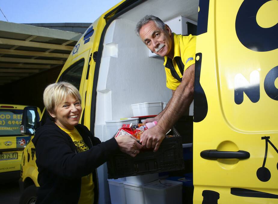IMPORTANT WORK: OzHarvest Newcastle manager Monique Maguire and driver Shane Johns are part of a strong contingent of hard-working employees and volunteers. Picture: Peter Stoop