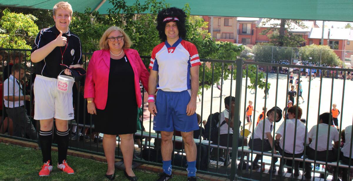 TEAM EFFORT: Year 11 student Ben Taylor, Head of School Erica Thomas and teacher Lee O'Brien got into the spirit of the soccer gala day, which was well supported.