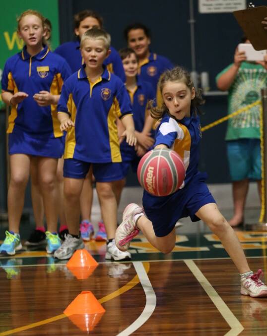 KEY MOVES: Dribbling in and out of cones was one of just a number of activities relative to basketball that each student was put through. Picture: Grant Sproule