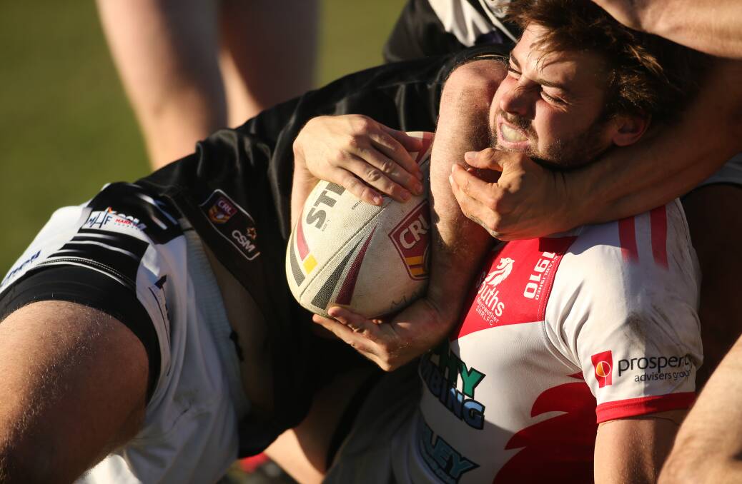 Souths centre Bryce Donovan is wrapped up against Maitland in Newcastle Rugby League.