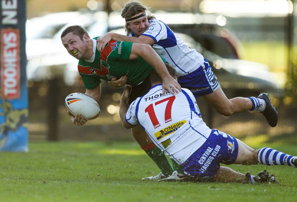 Wests player Simon Williams gets tackled against Central at Harker Oval.