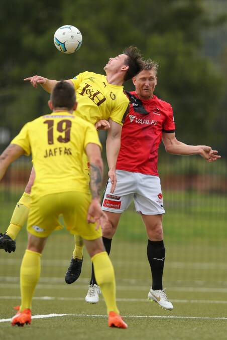 Lamtbon's Liam Odell and Edgeworth's Daniel McBreen in FFA Cup match at Speers Point.