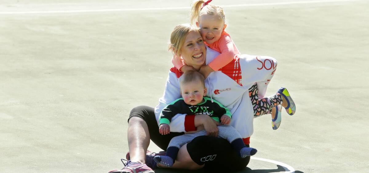 SOFTER SIDE: Souths Lions shooter Tiffany Gilmour with children Evie and Henry at Newcastle netball courts. Picture: Jonathan Carroll