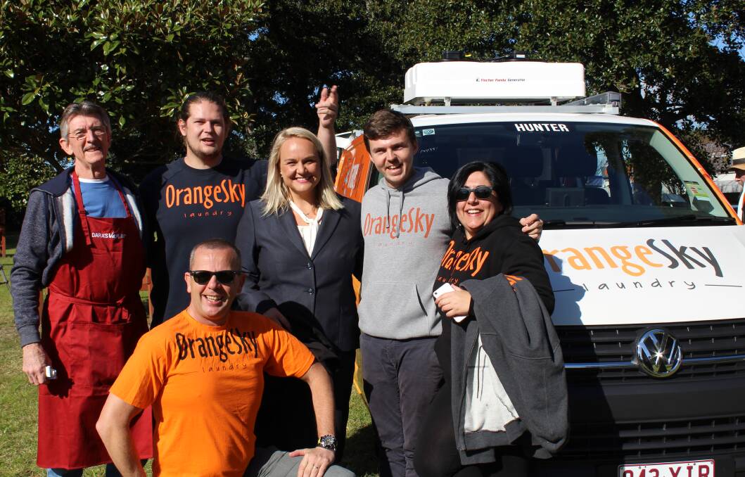 HUNTER GETS MOBILE: Orange Sky Laundry co-founders Lucas Patchett and Nic Marchesi, either side of Newcastle lord mayor Nuatali Nelmes, with volunteers at the launch of one of their free laundry vans in Newcastle on August 3.