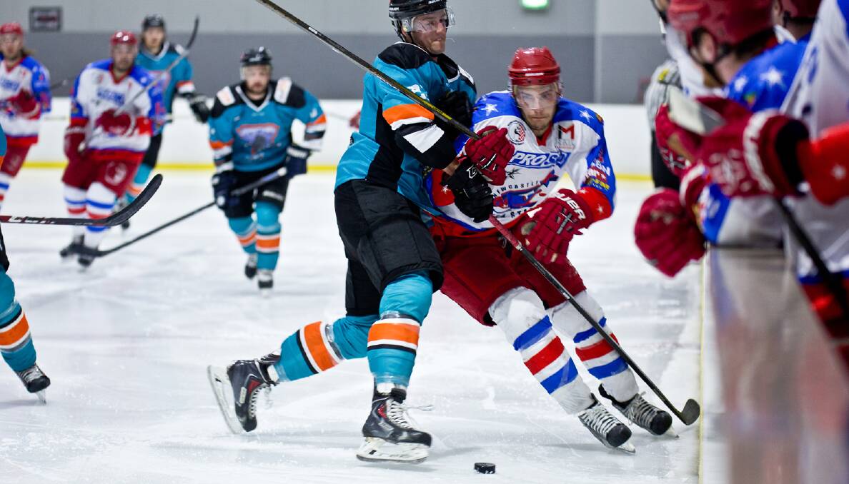 BATTLE OF WILLS: Newcastle North Stars import Scott Swiston battles a Sydney Ice Dogs player for the puck in Saturday's AIHL clash in Liverpool. Picture: Mark Bradford/Pic by Wulos