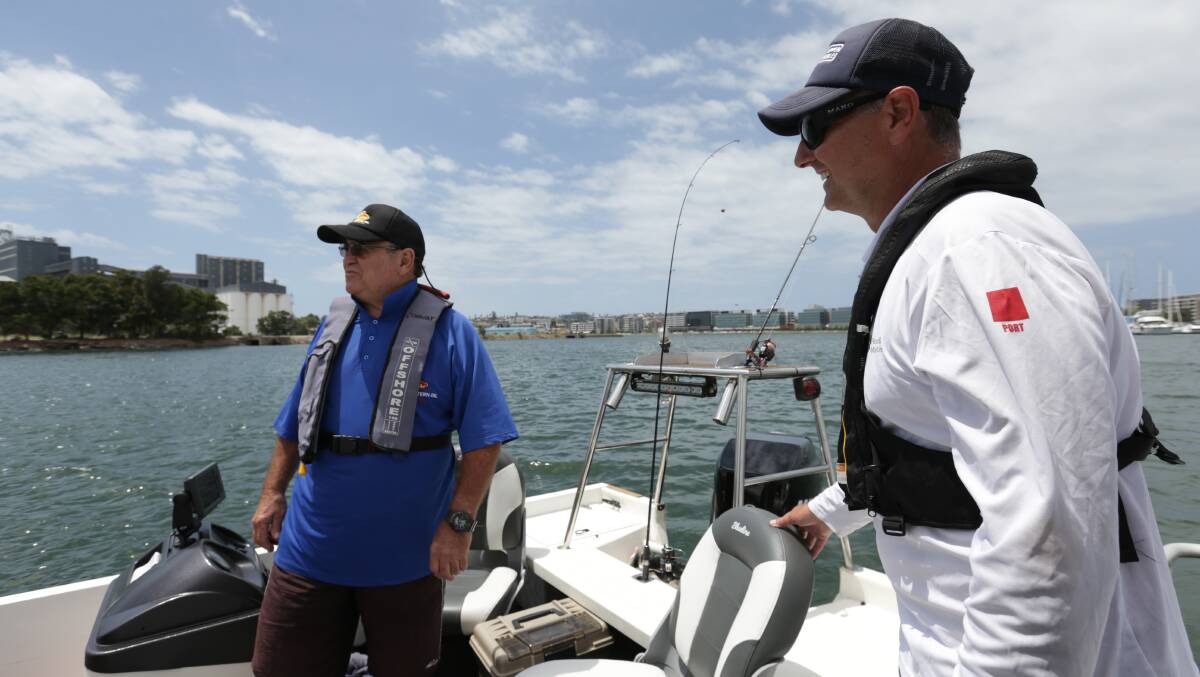 GOOD ADVICE: Boating Education Officer Stuart Everitt, right, speaks with Gary Conway, of Redhead, on Newcastle Harbour. Picture: Simone De Peak 