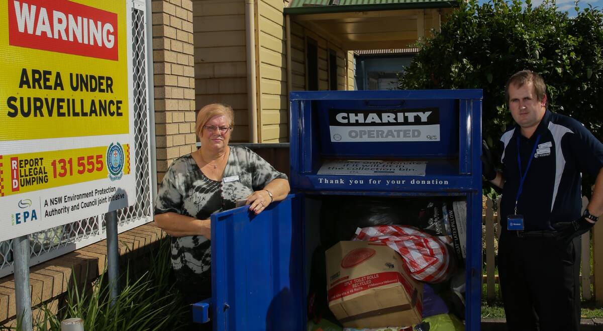 Disheartened: Cathy Hearn and Stephen Pedelty, from St Vincent de Paul Society's Mayfield shop, outside the charity bin. Picture: Jonathan Carroll