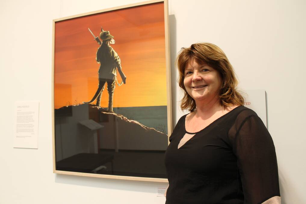 EMBODIED: Public programs co-ordinator Carol Edmonds with an illustration from An Anzac Tale by Greg Holfeld.