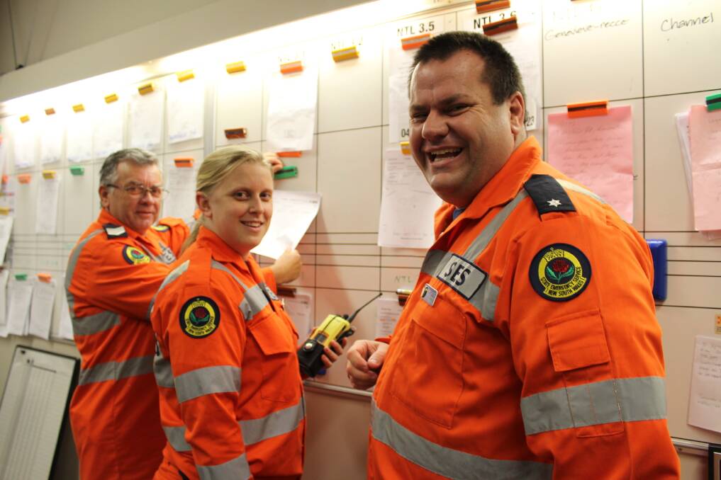 SES volunteers Mark Healey and Julia Koch with operations officer Garry Luxton at the Tighes Hill headquarters