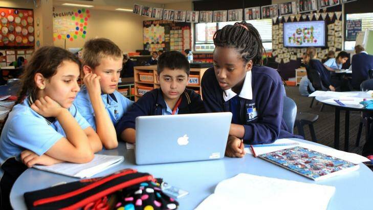 New-age learning: St Monica's Primary School students Nazanin Abdolllahihagh, Lachlan Roberts, Jackson Basha, and Salama Kunambi working together in a composite class and open study area. Photo: James Alcock