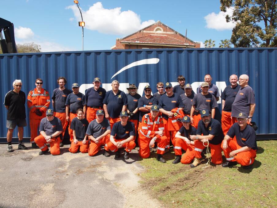 FEELING GOOD: Volunteers from Newcastle, Lake Macquarie and Cooranbong NSW SES units in front of the shipping container they loaded with hospital equipment to send to the Philippines.