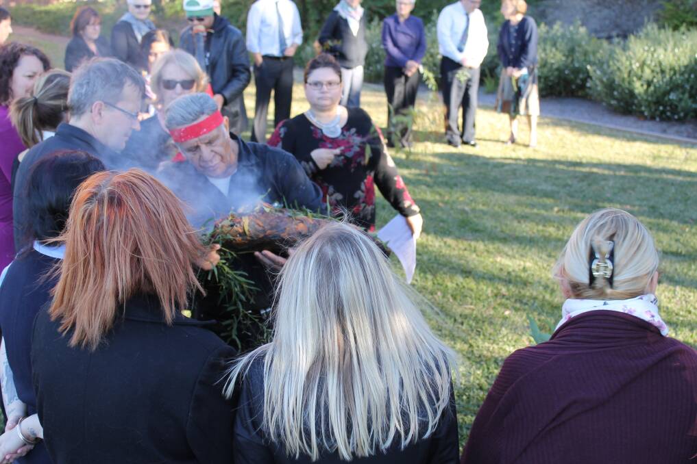 Uncle Bill Smith carries out the smoking ceremony at the Mater Hospital for NAIDOC Week.