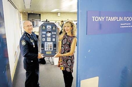 MEDAL BOARD: Superintendent John Gralton with Tony's wife, Sonia Tamplin, at the police training room dedicated to her late husband at Newcastle Police Station.