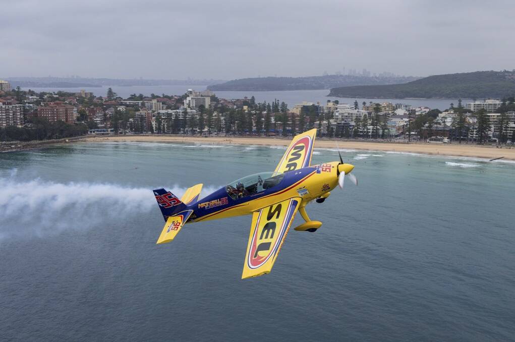 FLYING HIGH: Red Bull Air Race competitor Matt Hall, of Matt Hall Racing, soars over Sydney Harbour.
