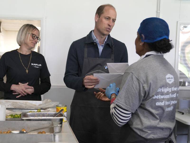 Prince William has been given cards for his wife Kate and King Charles by a volunteer. (AP PHOTO)