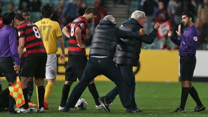 Marcello Lippi has to be held back after his side received their second red card. Photo: Brendan Esposito