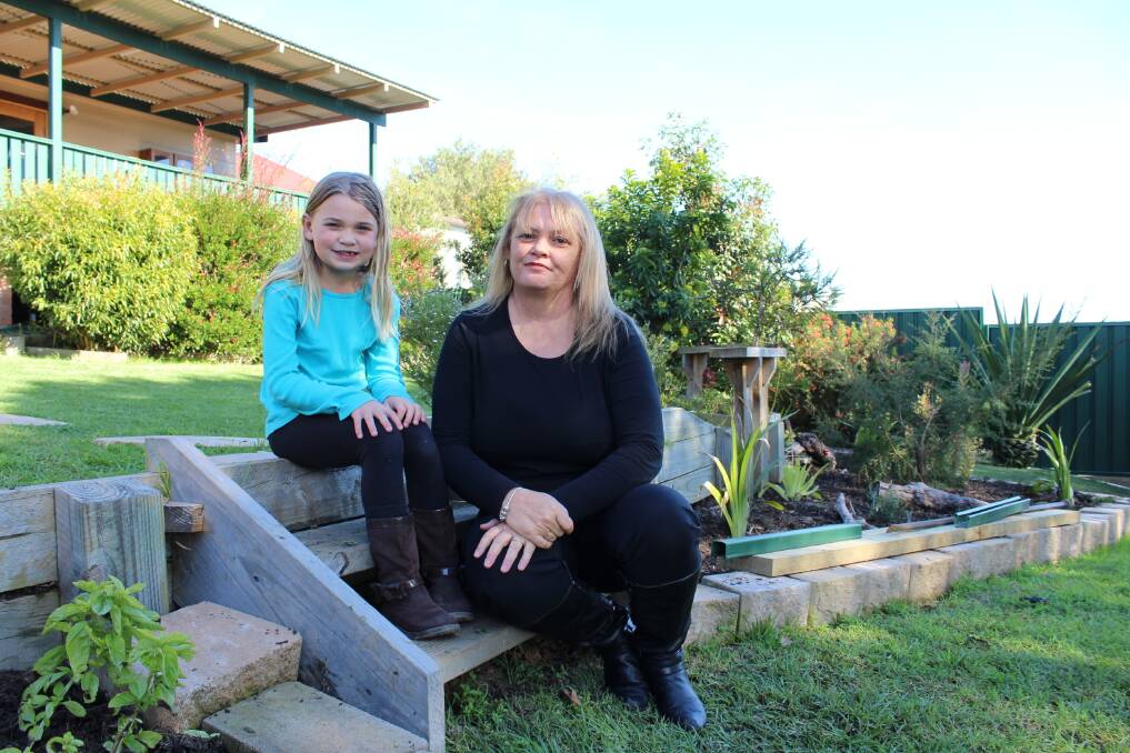 FLOCK HERE: Lily McCraw, 4, with her mother Karen in the backyard of their Boolaroo home.