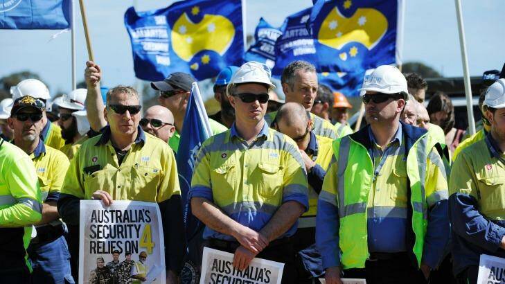 Workers from ASC listen to speakers outside the ship building headquarters in Adelaide. Photo: David Mariuz