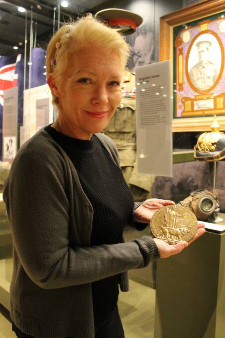 Newcastle museum deputy director Julie Baird with the Dead Man‚Äôs Penny awarded to Ray Hobden‚Äôs family.