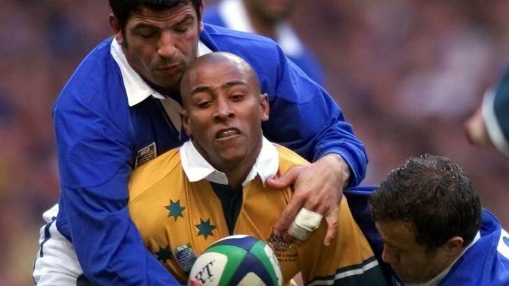 Rough treatment: George Gregan is tackled by the French defence during the 1999 World Cup final. Photo: ADAM BUTLER