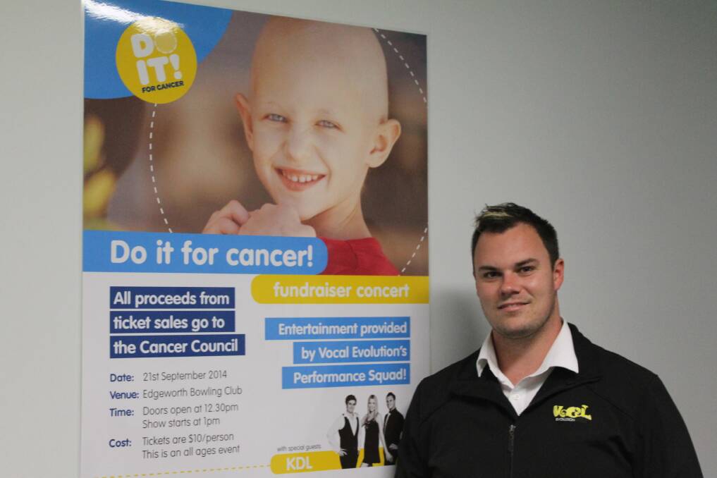 Vocal Evolution owner David Geise with a poster for the Do It For Cancer concert.