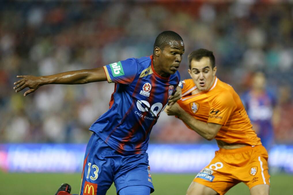 NOT ENOUGH: Newcastle Jets' Edson Montano tries to push past Brisbane Roar's Steven Lustica, who later scored.