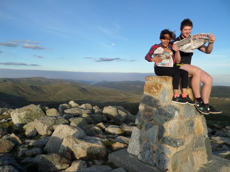 ALL THE NEWS: Candice Tan and Hamish Powell reading The Star on the summit of Mt Kosciuszko. Picture: Greg Powell
