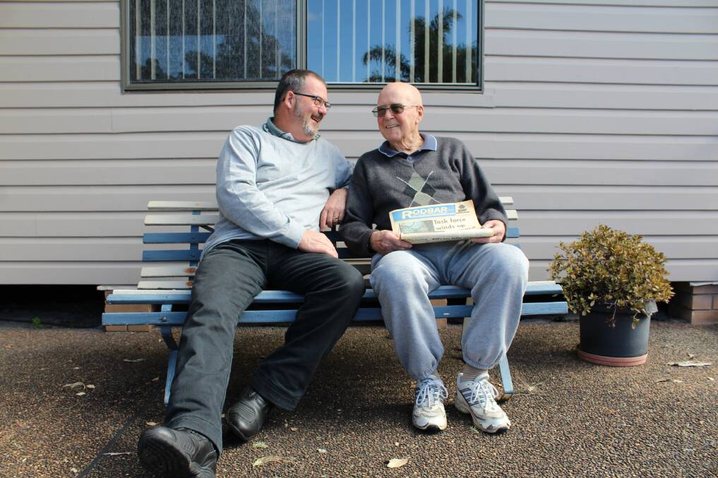 MANY MEMORIES: Bob Newitt and his dad Keith reminisce about BHP as they flick through a copy of BHP publication Rodbar, with Bob on the front page.